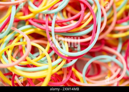 Vibrant collection of assorted rubber bands in various colors, ideal for organizing office supplies, crafting projects, and DIY activities. Perfect fo Stock Photo