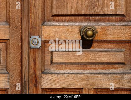 Closed wooden door with metal handle and key hole Stock Photo