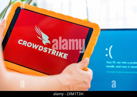 Prague, Czech Republic - July 25, 2024: CrowdStrike cybersecurity software and Windows blue screen. Stock Photo