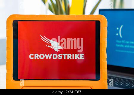 Prague, Czech Republic - July 25, 2024: CrowdStrike cybersecurity software and Windows blue screen. Stock Photo