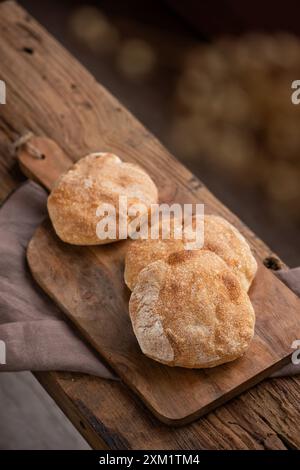 Freshly baked ciabatta, Italian bread,  on wooden cutting board. Stock Photo