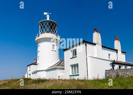 An old 1800s era lighthouse on Caldey Island near the Welsh town of Tenby Stock Photo