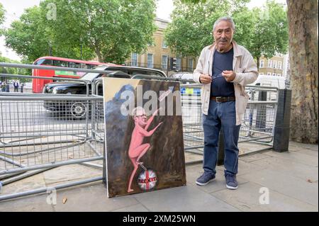 Artist Kaya Mar outside Downing Street with a picture of the new Prime Minister, Sir Keir Starmer. 24th July 2024. Stock Photo