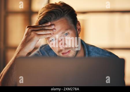 Stress, man or frustrated by laptop in startup for website deadline, reading news or phishing email. Face, night or confused designer in tech with Stock Photo