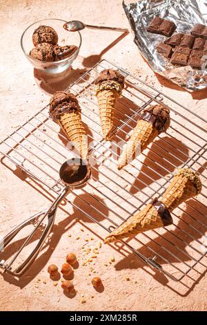 Chocolate ice cream on a metal rack with scoop from stainless steel, flat lay, top view Stock Photo