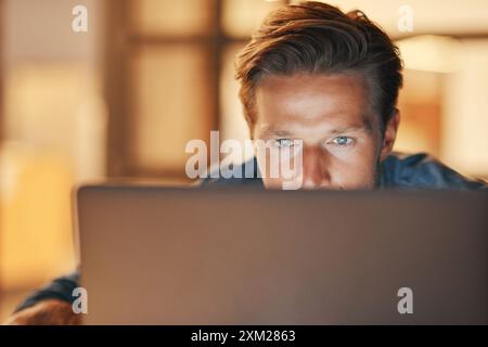 Laptop, night and business man reading email for project, research information and deadline. Computer, creative and web designer working on code, app Stock Photo