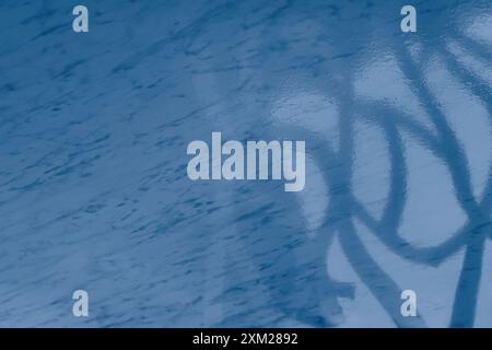 Light from the window on the blue marble floor inside the building. A Game of shadows from the falling rays of the sun on a stone surface Stock Photo