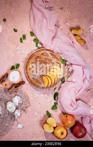 Delicious traditional apple pie with apple fruits and ingredients for it on stone surface, flat lay, top view Stock Photo