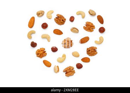 Background from various nuts and seeds with copy space for text in the form of a heart. Isolated on white background. Flat lay, top view Stock Photo