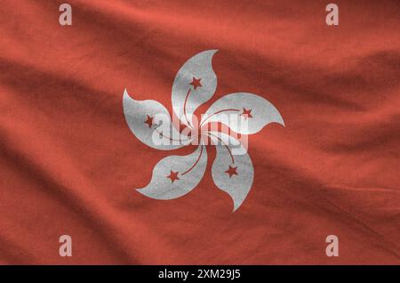 Hong kong flag depicted on folded wavy fabric of old cloth close up Stock Photo