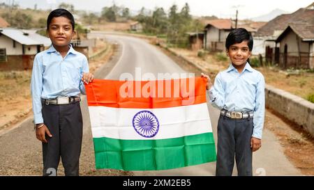 Concept of Indian independence or republic day celebration. School children holding an Indian flag Stock Photo