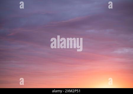 Sunrise sky above a city. Incredible natural colors. Red, orange, purple, dark blue. Heaven. Stock Photo
