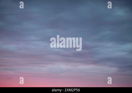 Sunrise sky above a city. Incredible natural colors. Red, orange, purple, dark blue. Heaven. Stock Photo