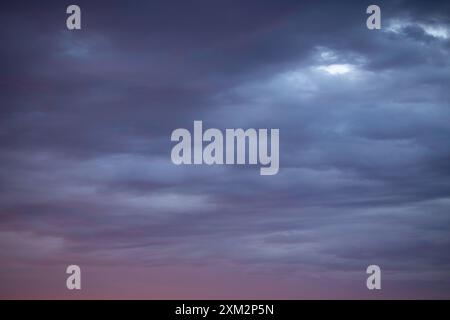 Sunrise sky above a city. Incredible natural colors. Red, orange, purple, dark blue. Heaven. Stock Photo