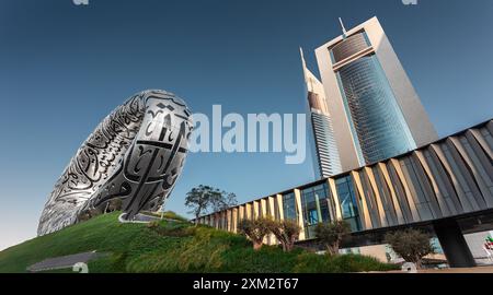 Dubai, UAE, Museum of the Future in Dubai along with Emirates towers with a beautiful afternoon golden sunlight reflected on each building Stock Photo