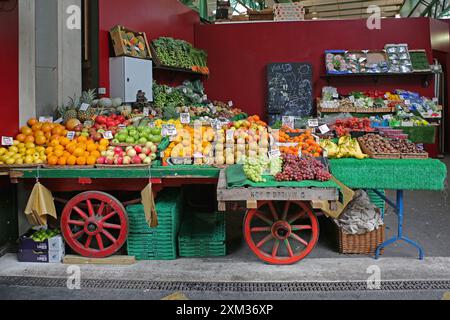 London, United Kingdom - November 20, 2013: Large Selection of Fresh Fruits and Vegetables Produce at Borough Market Cart Stall. Stock Photo