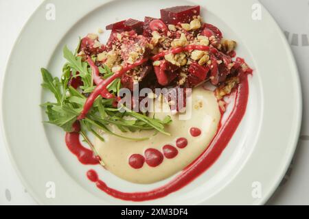 Beetroot salad served with hummus and fresh arugula Stock Photo