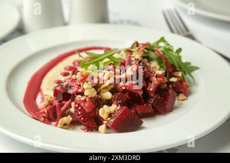 Beetroot salad served with hummus and fresh arugula Stock Photo