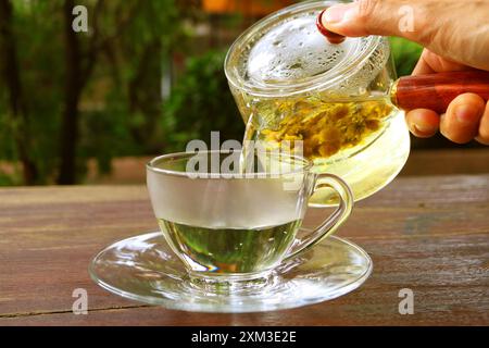 Hot Chrysanthemum Tea Being Served on the Garden Table Stock Photo
