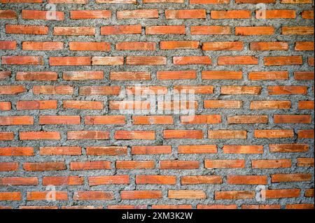 Weathered aged of orange brick wall masonry background in construction site Stock Photo