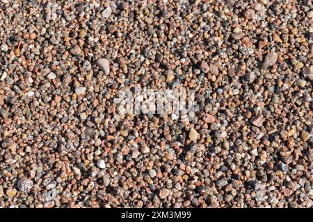 Coarse wet sand on the beach. Top view, natural background photo texture of Baltic Sea coast Stock Photo