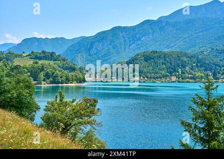 Lago di Ledro, Italy - July 21, 2024: Lago di Ledro in Italy, surrounded by lush vegetation and the impressive Italian Alps *** Lago di Ledro in Italien, umgeben von üppiger Vegetation und den beeindruckenden italienischen Alpen Stock Photo