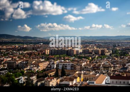 Scenic tilt-shift view of Granada city from Alhambra hill in Andalusia, Spain. Captures urban landscape and distant mountains. Stock Photo