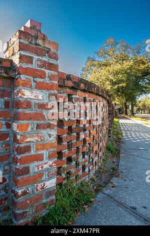 Historic brickwork fence along sidewalk Stock Photo