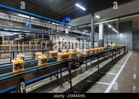 Production line of bottling of beverage into plastic bottles and packing. Stock Photo