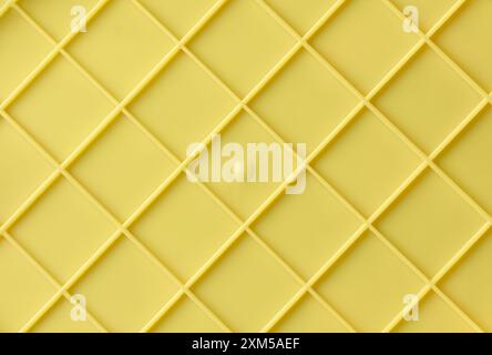 yellow plastic surface with embossed grid pattern abstract texture, ribbed or reinforced plastic background backdrop or wallpaper for graphic design Stock Photo