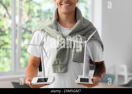 Male engineer with wind turbine models in office, closeup Stock Photo