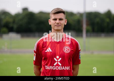 Duesseldorf, Germany. 25th July, 2024. Soccer: Bundesliga 2, Fortuna Düsseldorf photo shoot. Yannik Engelhardt. Credit: Marius Becker/dpa - IMPORTANT NOTE: In accordance with the regulations of the DFL German Football League and the DFB German Football Association, it is prohibited to utilize or have utilized photographs taken in the stadium and/or of the match in the form of sequential images and/or video-like photo series./dpa/Alamy Live News Stock Photo