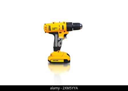 Yellow electric cordless drill isolated with battery on white background , Mechanic tools concept Stock Photo