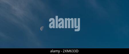 The moon in the blue sky. Panoramic sky background Stock Photo
