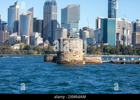 Fort Denison ( Pinchgut island) in Sydney harbour with martial tower, former penal colony, Sydney city centre skyscrapers behind,NSW,Australia Stock Photo