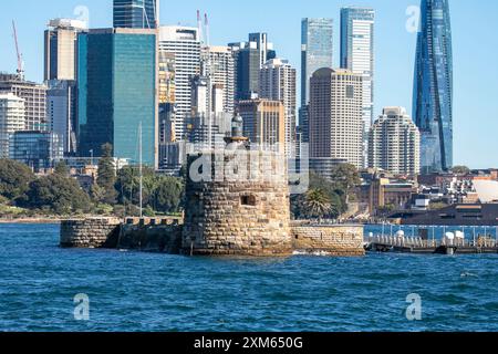 Fort Denison ( Pinchgut island) in Sydney harbour with martial tower, former penal colony, Sydney city centre skyscrapers behind,NSW,Australia Stock Photo