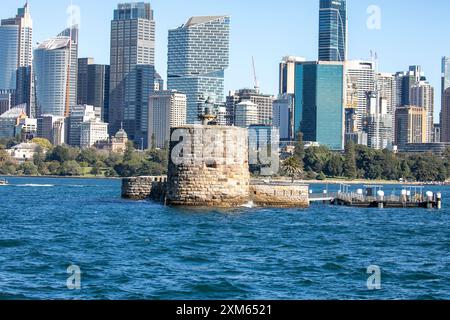 Fort Denison ( Pinchgut island) in Sydney harbour with martial tower, former penal colony, Sydney city centre skyscrapers behind,NSW,Australia Stock Photo