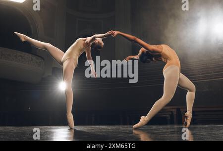 Women, ballet and stage for team in dance, creative and practice performance in rehearsal. People, holding hands and technique for physical talent at Stock Photo