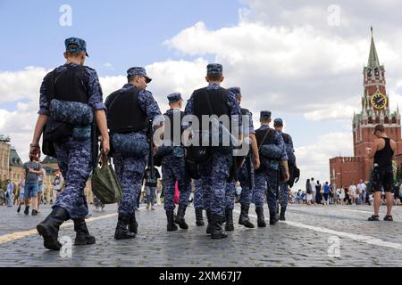 Soldiers of russian military forces of National Guard walking down the Red Square on Kremlin tower background Stock Photo