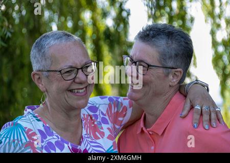 Happy older gay couple with glasses hugging and smiling Stock Photo - Alamy