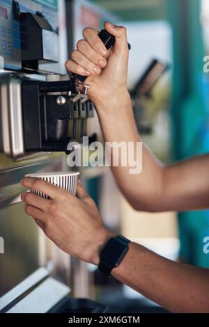 Hands, person and ice cream scooper with working, restaurant and catering in summer for customer service. Frozen yoghurt, cup and food truck in Stock Photo