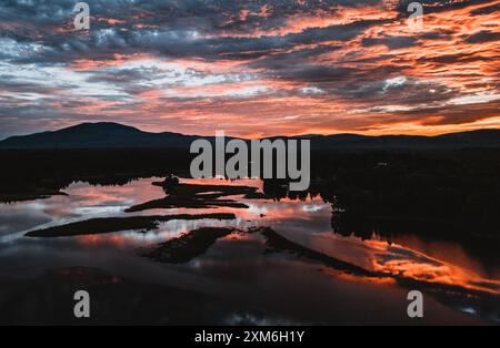 Vibrant red sunset over beautiful Flagstaff Lake, Maine Stock Photo