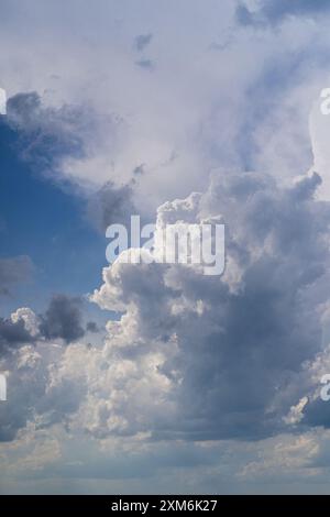 Low angle view of sunlight streaming through clouds in sunset. Stock Photo