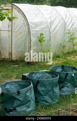 Light fabric sacks for various uses in the garden foil plant greenhouse Stock Photo