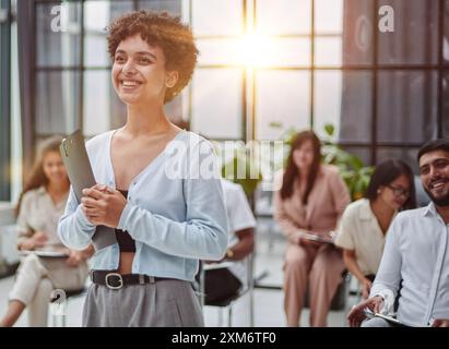 Young woman coach speaker giving flipchart presentation Stock Photo