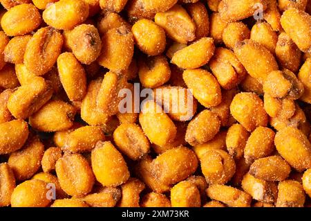 Roasted salted Corn Nuts with Spice and Sauce in bowl on rustic table, Nut concept Stock Photo