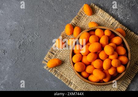 Peanut chips with sauce in bowl on wooden background, traditional roasted Turkey nut Stock Photo