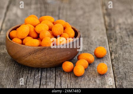 Peanut chips with sauce in bowl on wooden background, traditional roasted Turkey nut Stock Photo