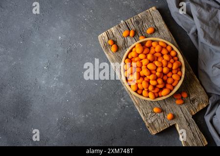 Peanut chips with sauce in bowl on wooden background, traditional roasted Turkey nut Stock Photo