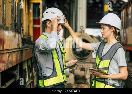 Safety engineer supervisor female officer blame young new worker for not properly firm and safe wearing helmet head protection equipment when working Stock Photo